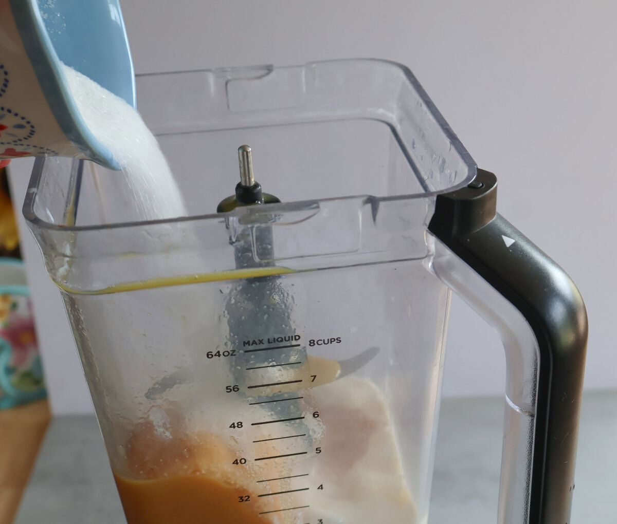 Adding ingredients for the Creamsicle orange frost to the blender.