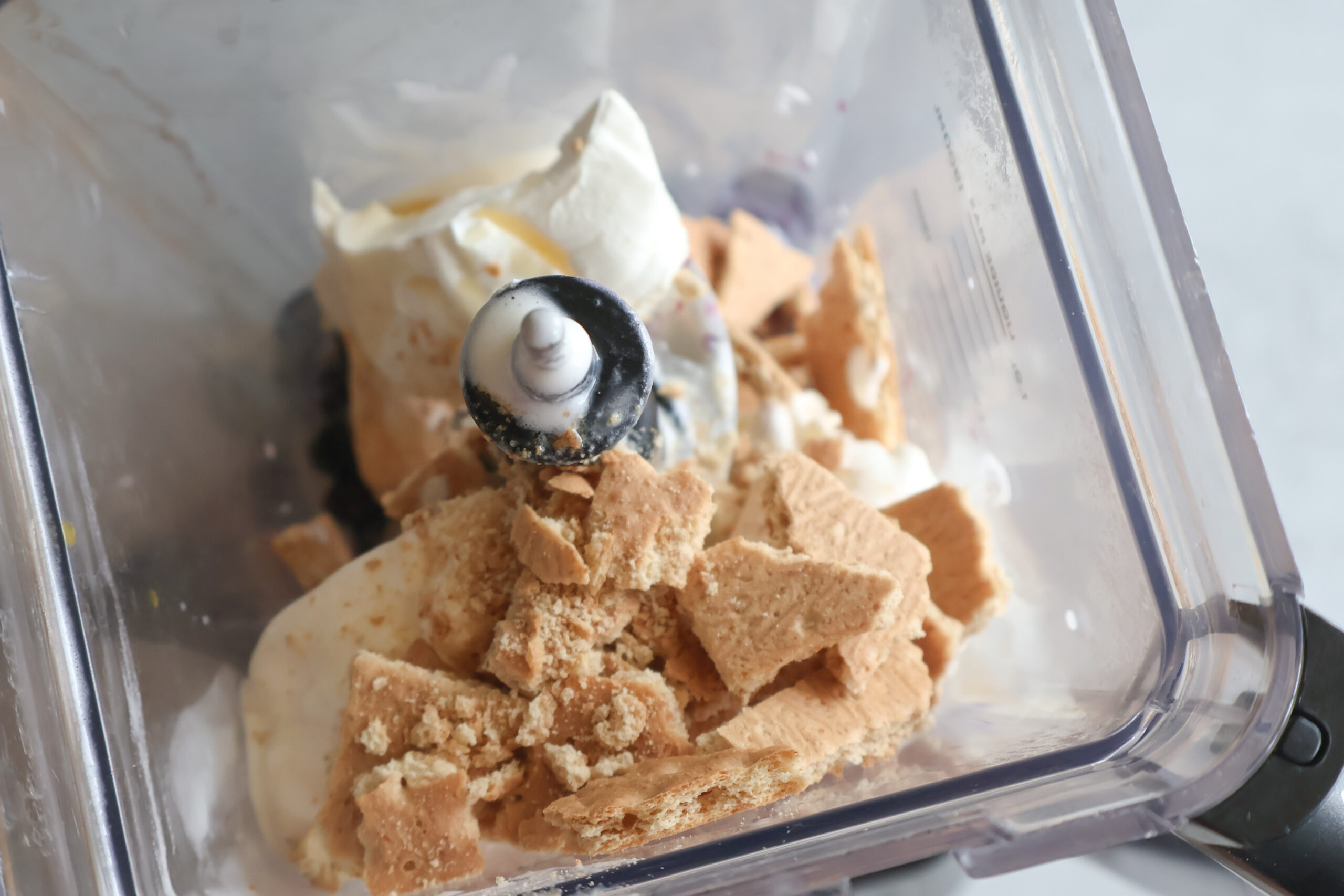 Ingredients for the blueberry cheesecake milkshake in a blender.