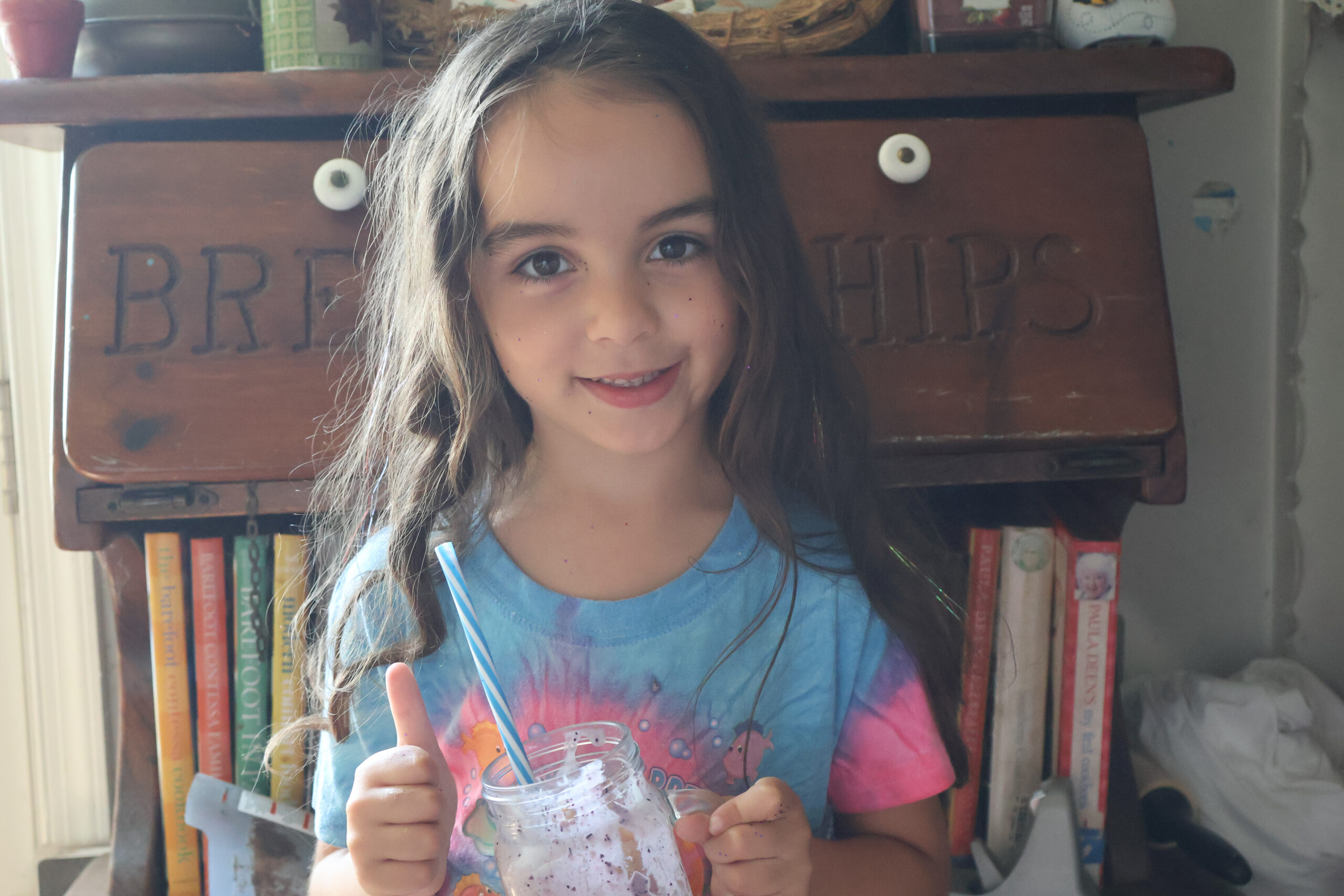 My little girl ejoying the blueberry cheesecake milkshake with a thumbs up!