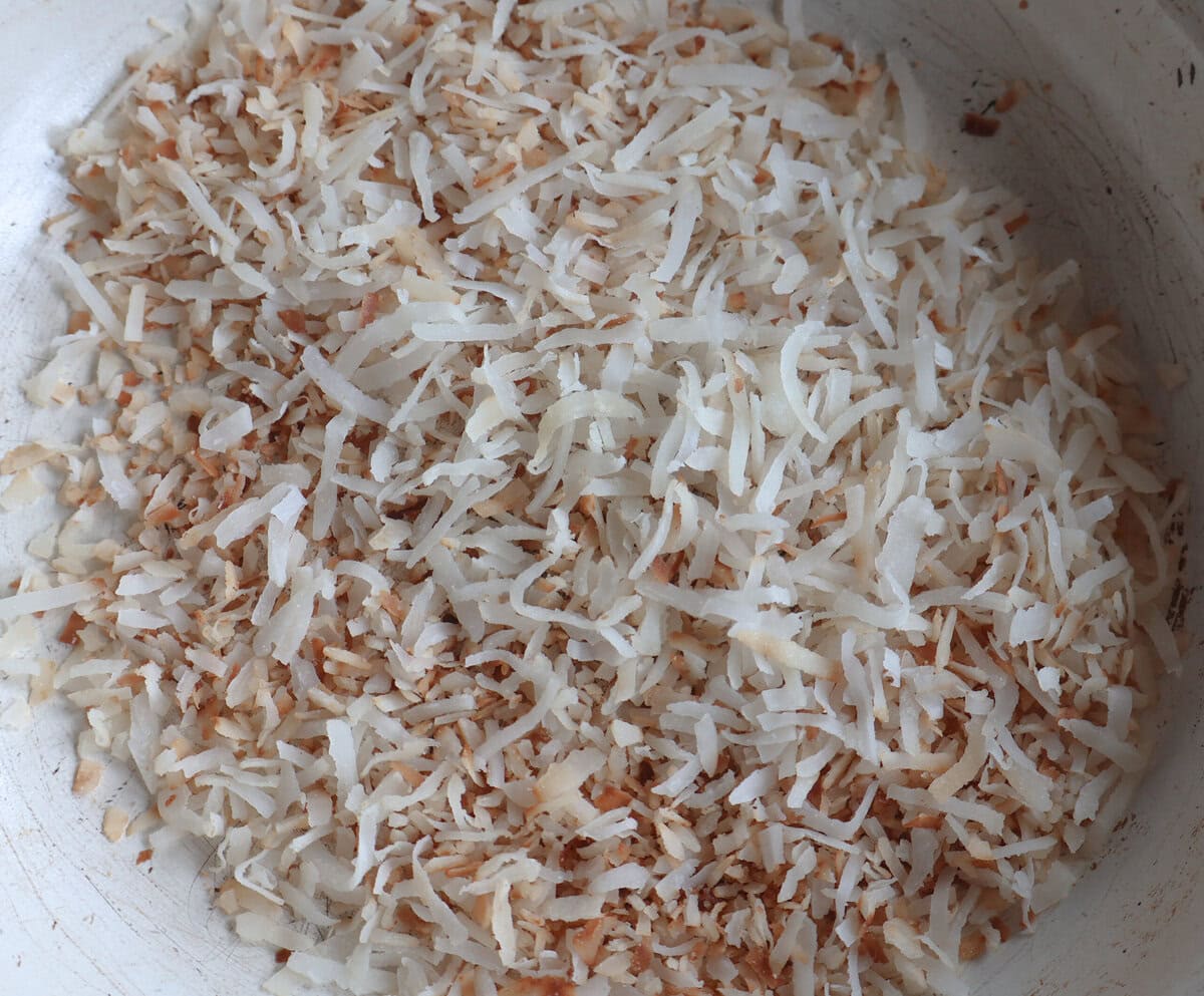 Toasted coconut in a skillet cooked to golden brown.