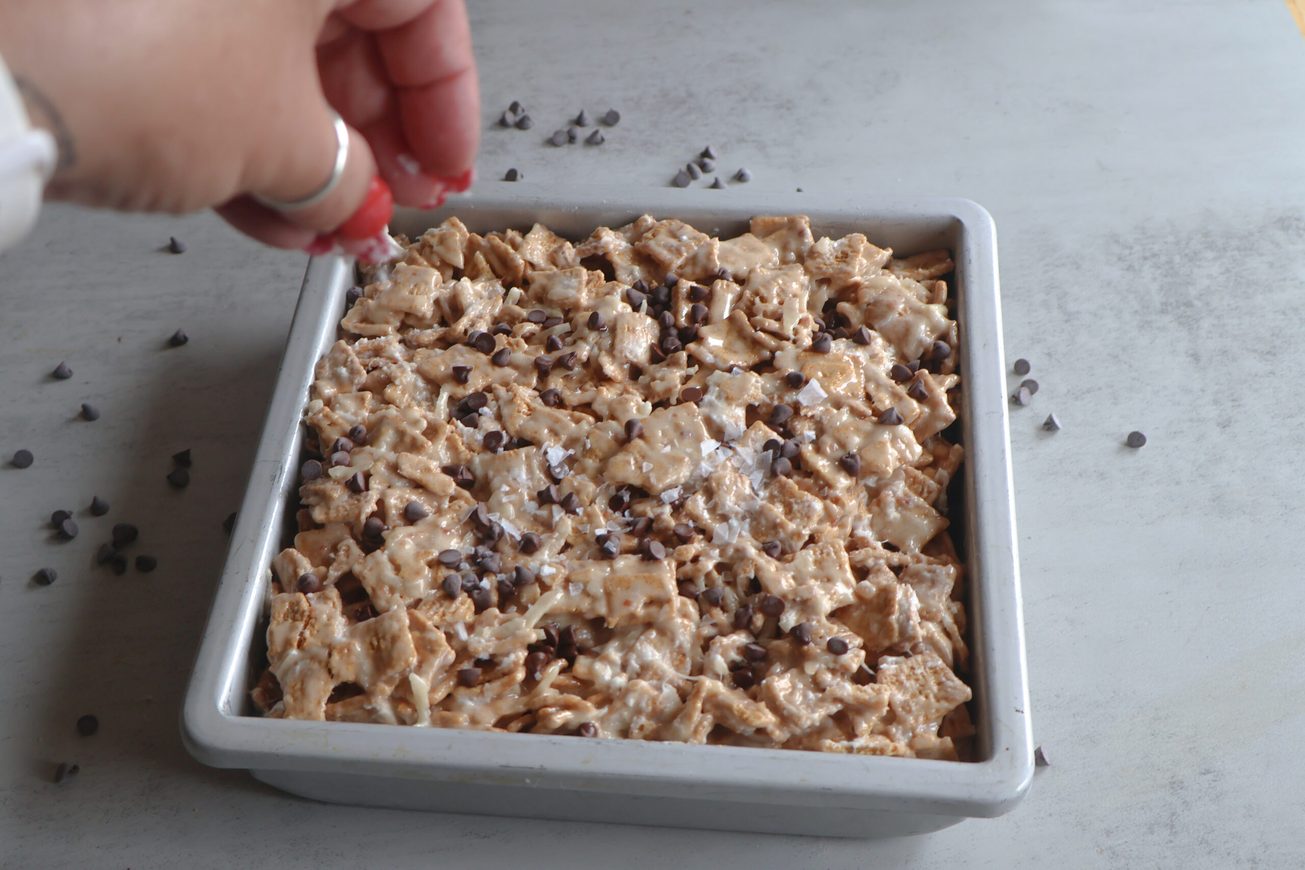 Salted honey golden grahams crunch bars in a pan with mini chocolate chips.