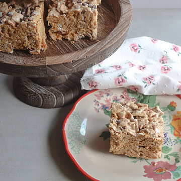 salted honey golden graham crunch bars on a cake stand and a plate.
