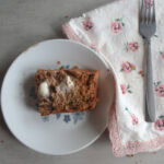 Chocolate Chip Zucchini Carrot Bread on a small plate with butter and a fork.