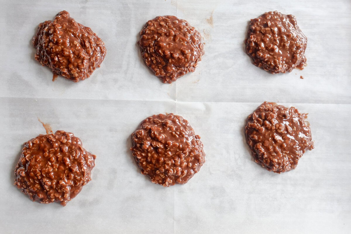finished chocolate peanut butter no bake cookies cooling on parchment paper.