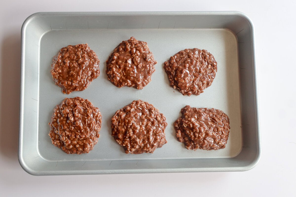 finished chocolate peanut butter no bake cookies on a sheet pan.