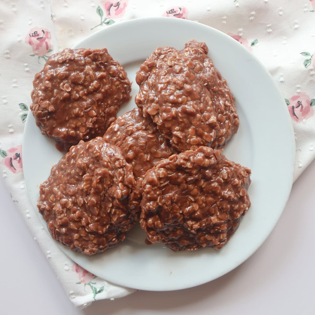 chocolate peanut butter no bake cookies on a white plate.