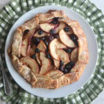 Blueberry Peach Galette on a white plate with a green and white placemat.
