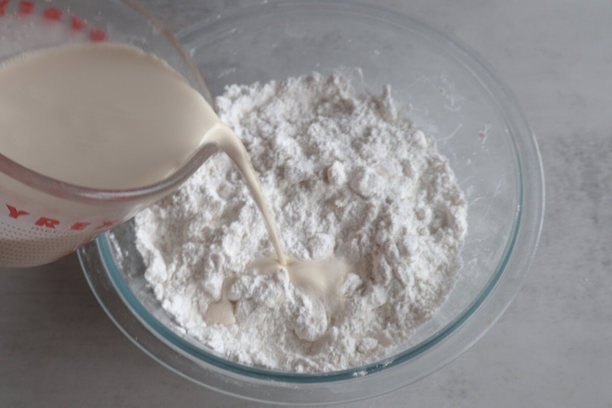 wet ingredients being added to the dry ingredients.