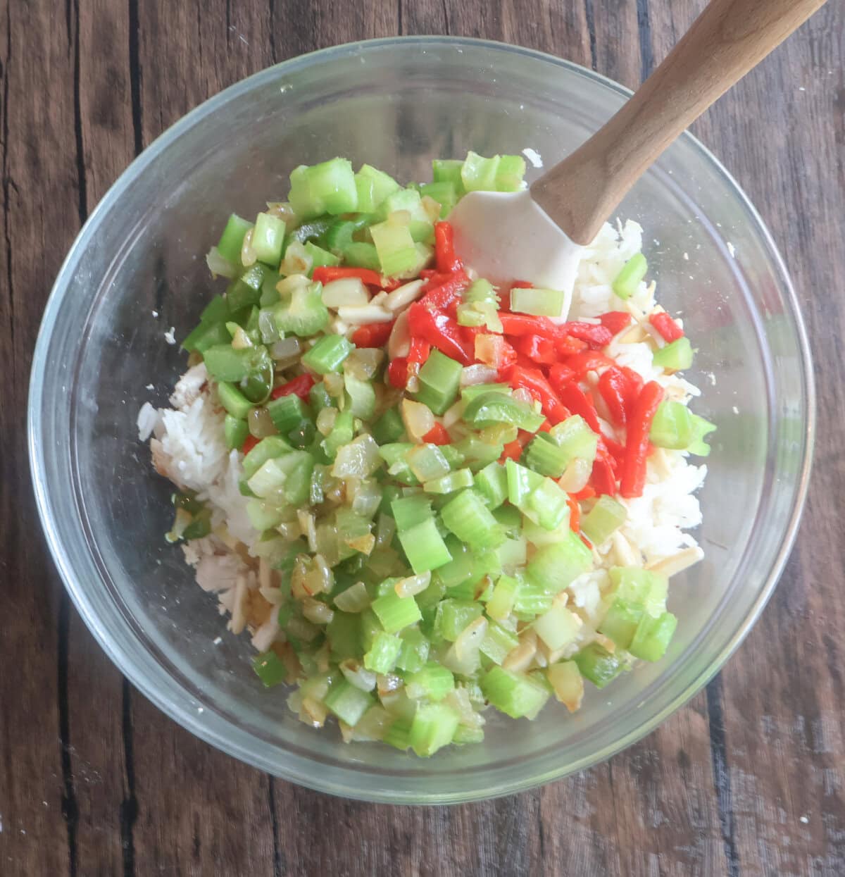 peppers and onion mixed with rice in a glass bowl.