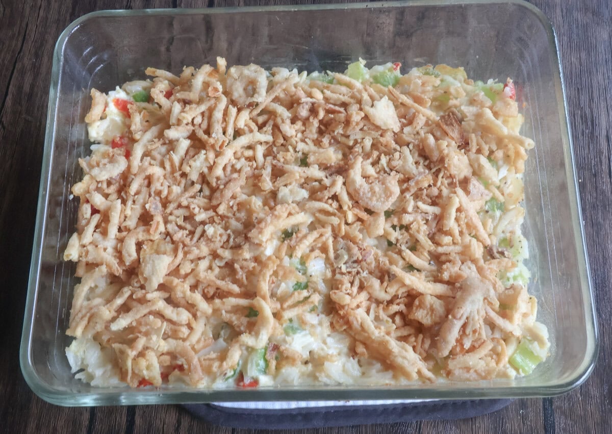 baked chicken salad in a baking dish topped with french fried onions.