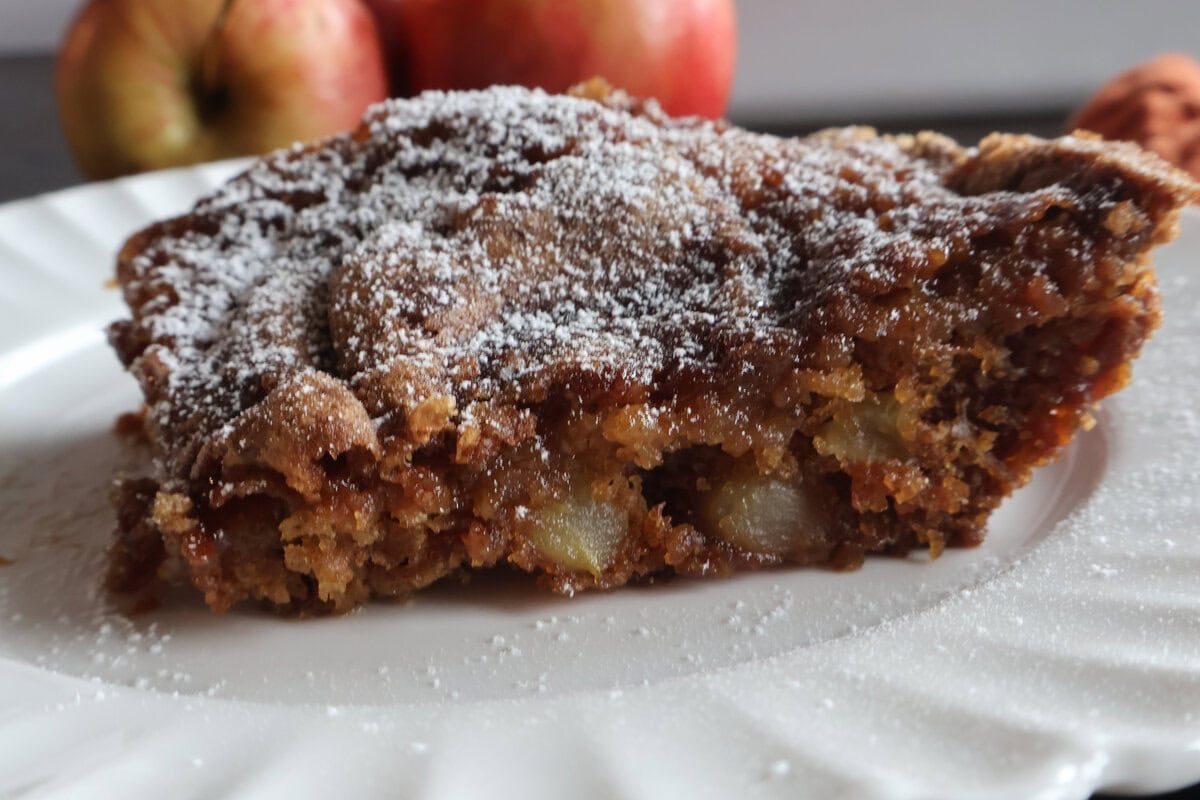 slice of apple cake with powdered sugar.