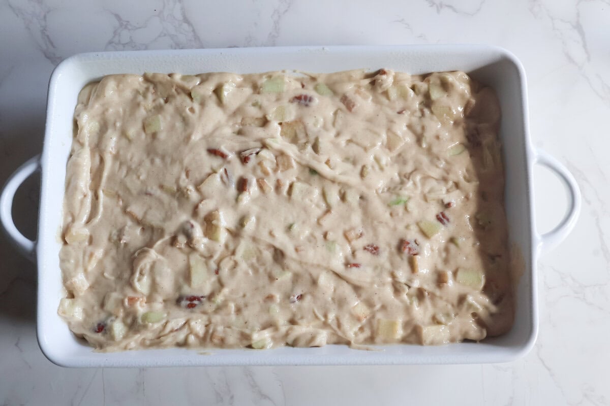 Apple cake in a prepared pan.