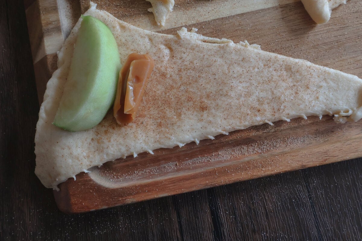 seasoned crescent dough with an apple slice and caramel.