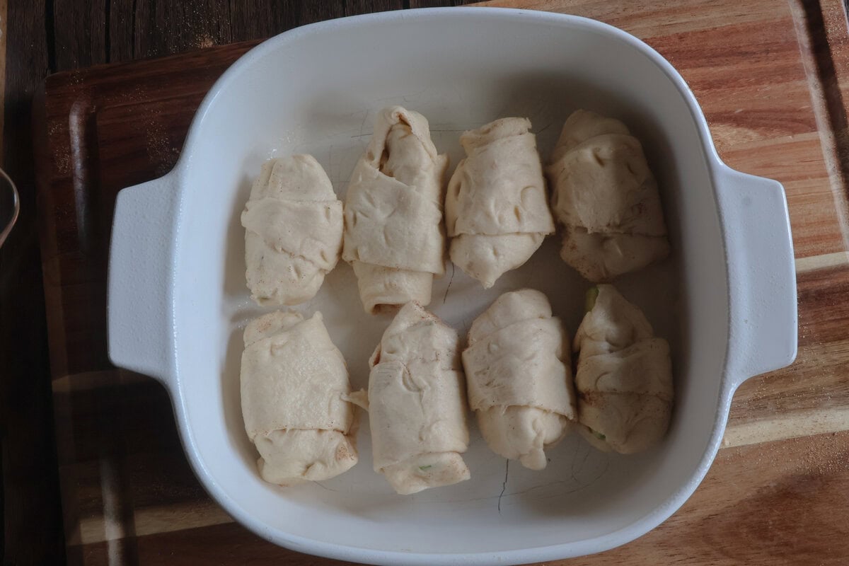 caramel apple dumplings in a white dish.