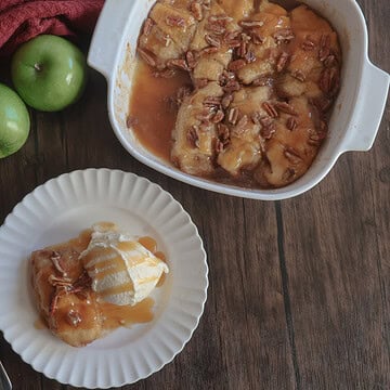 caramel apple dumplings in a white dish and on a white plate with fresh apples.
