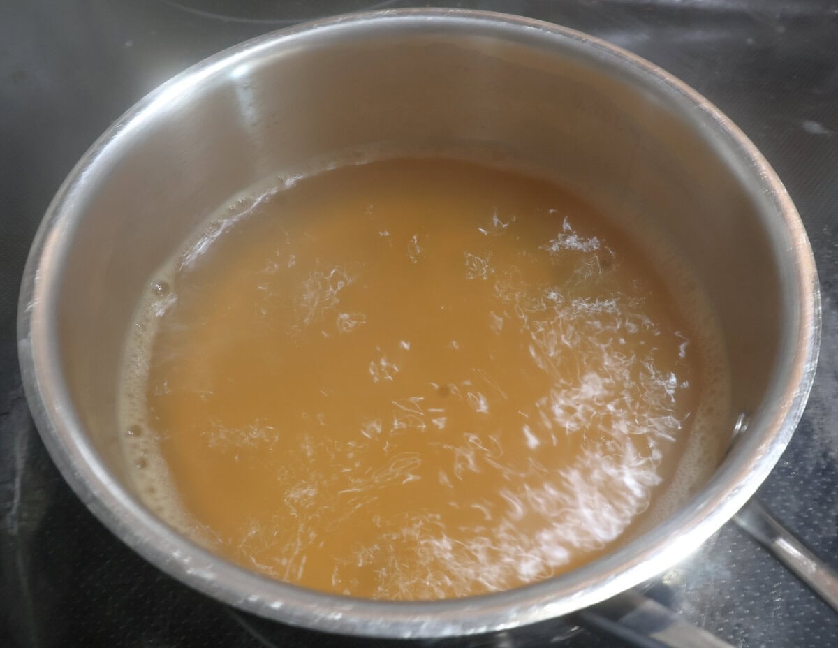 apple cider simmering in a pot.