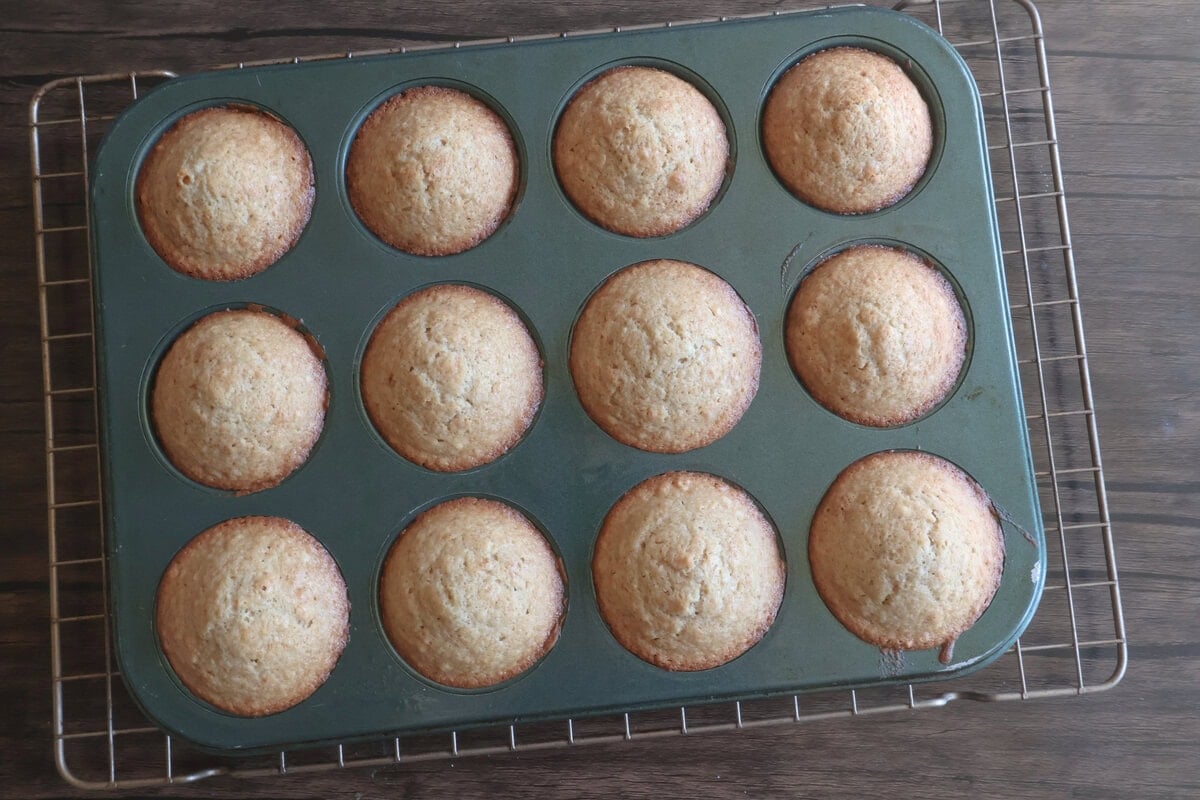 baked apple cider donut muffins in a pan.