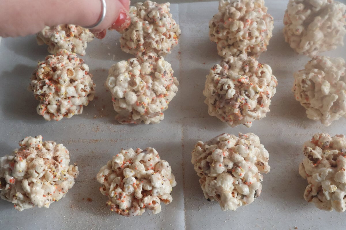 brown butter popcorn balls sprinkled with cinnamon sugar.