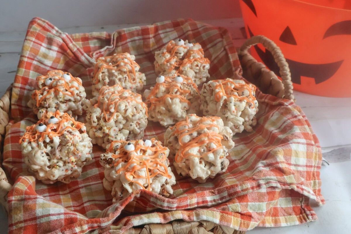 brown butter popcorn balls in an orange napkin.