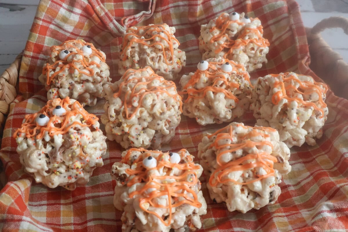 brown butter popcorn balls in an orange napkin