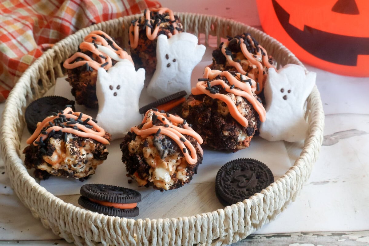 cookies and cream popcorn balls in a basket with ghost peeps.