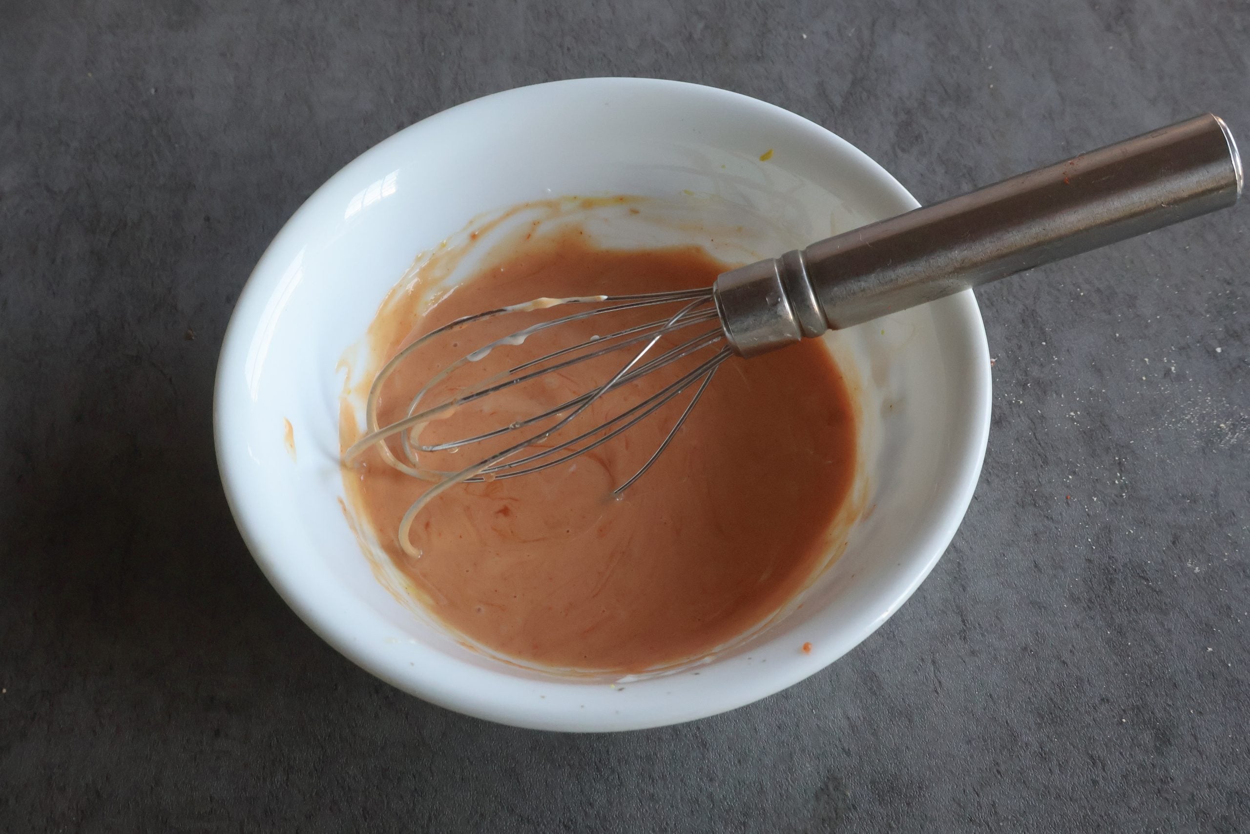 sauce ingredients mixed together in a white bowl.