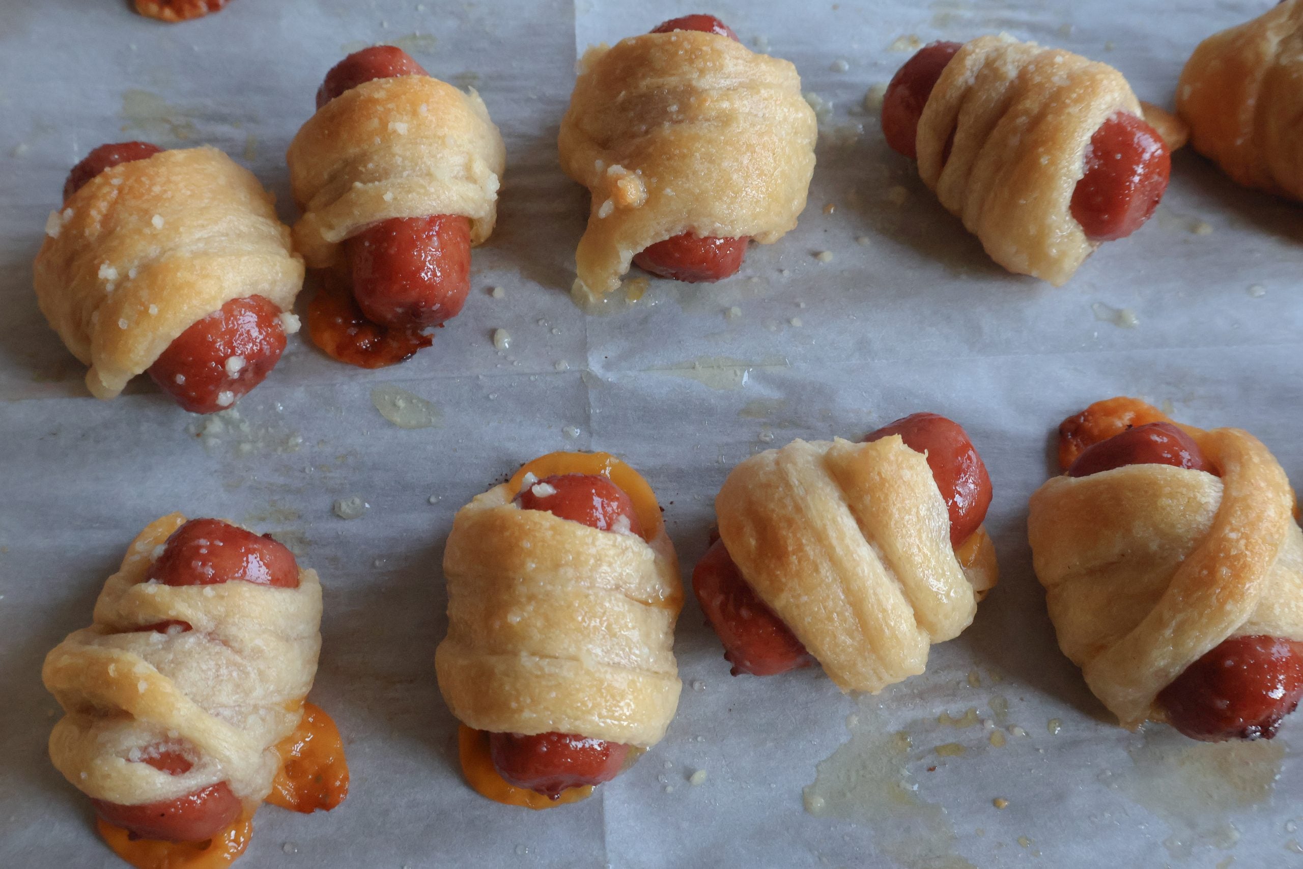 mini mummy hot dogs bakes on a sheet pan.